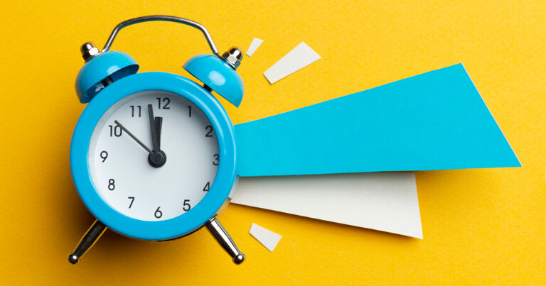 A clock that reads 11:57 has an exaggerated alarm that resembles blue and white lines coming out of its right side. 